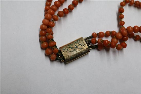 A group of assorted coral jewellery, including necklaces.